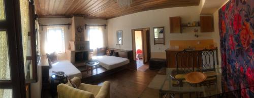 a living room with a couch and a table at Guesthouse Kontogianni - Materka in Nymfaio