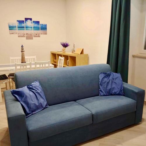 a blue couch with two pillows in a living room at YourHome - Alisea Home in Nerano