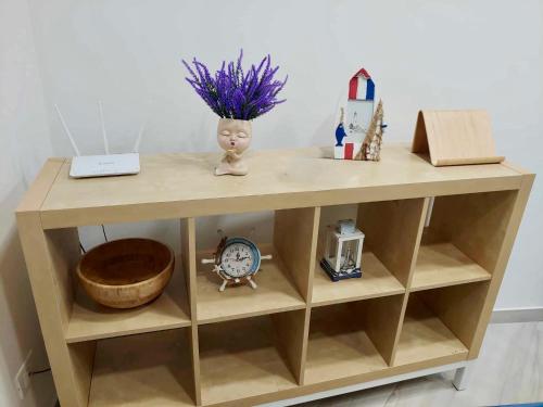 a wooden desk with a clock and a bowl at YourHome - Alisea Home in Nerano