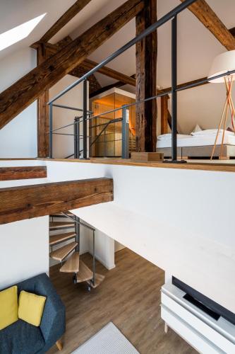 a room with a loft with a bed and a couch at Goldkind Feine Wohn- & Schlafstuben in Heppenheim an der Bergstrasse