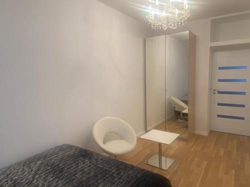 a bedroom with a bed and a chair and a mirror at Vienna Luxury Dream Home in Vienna