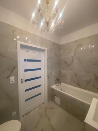 a bathroom with a white door and a chandelier at Vienna Luxury Dream Home in Vienna