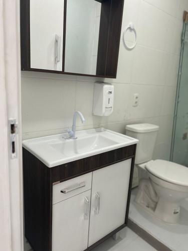 a bathroom with a sink and a toilet at Casa Pérolas do Mar in Balneário Camboriú