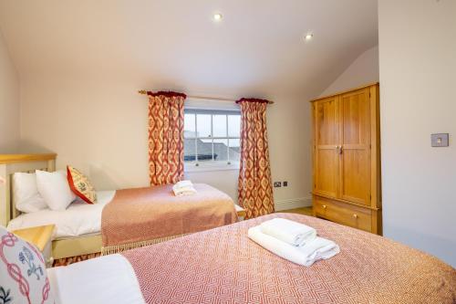 a bedroom with two beds and a window at Apartment 4 - The Kings in York