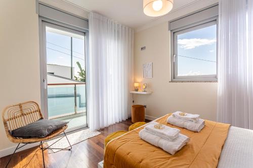 a bedroom with a bed and a large window at Moradia Vista Atlântico in Funchal