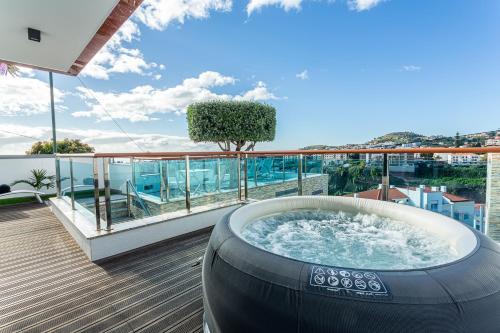 a hot tub on the deck of a house at Moradia Vista Atlântico in Funchal