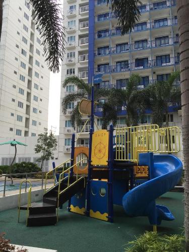 a playground with a slide in front of a building at Sea Residences MoA Manila in Manila