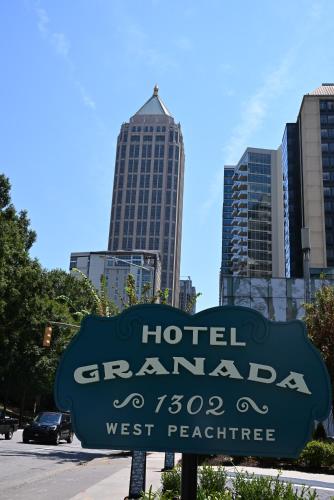 a sign for a hotel garage in front of a city at Hotel Granada, a Design Hotel in Atlanta