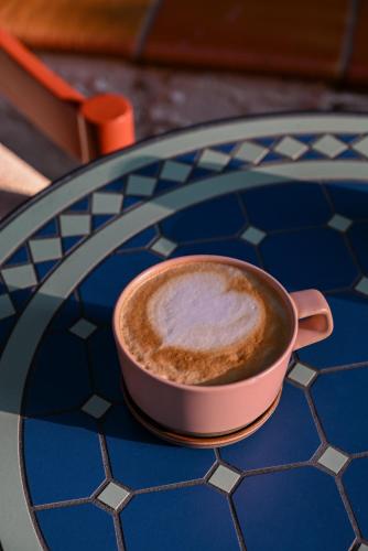 a cup of coffee sitting on top of a table at Hotel Granada, a Design Hotel in Atlanta