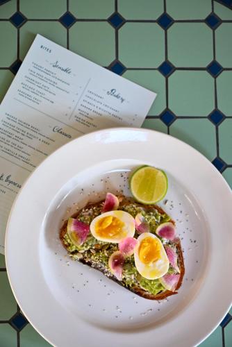 a plate with a piece of toast with eggs on it at Hotel Granada, a Design Hotel in Atlanta
