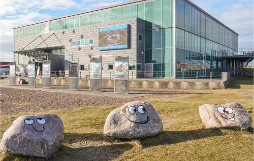 a building with three large rocks with faces on it at Holiday Home Lemvig 12 in Lemvig