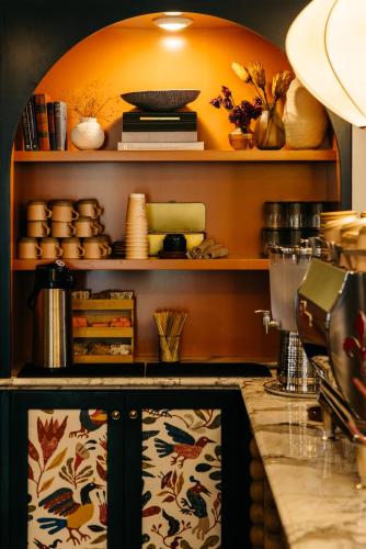 a kitchen with a counter with plates and bowls on shelves at Hotel Granada, a Design Hotel in Atlanta