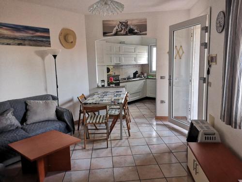 a living room with a couch and a table at Alloggio Residence Sa Tanca in Valledoria