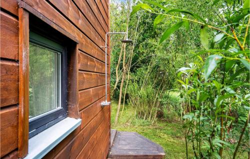 a window on the side of a wooden house at Three-Bedroom Holiday Home In Grenaa in Grenå