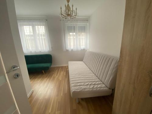 a living room with a white couch and a chandelier at Vienna Luxury Dream Home in Vienna