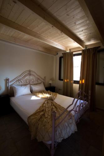 a bedroom with a large bed with a wooden headboard at 5 Stars Villas in Svoronata