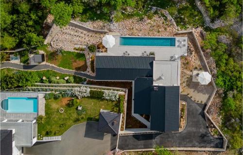 an aerial view of a house with a swimming pool at Villa Green Wave in Kostrena