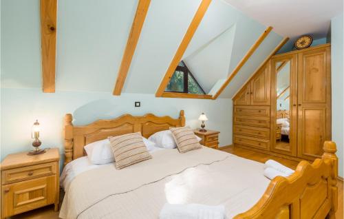 a bedroom with a large bed with white sheets at Cozy Home In Lokve With Jacuzzi in Lokve