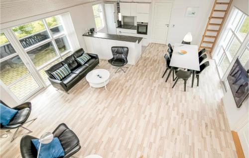 an overhead view of a living room with a table and chairs at Holiday Home Engdraget With Fireplace in Løkken
