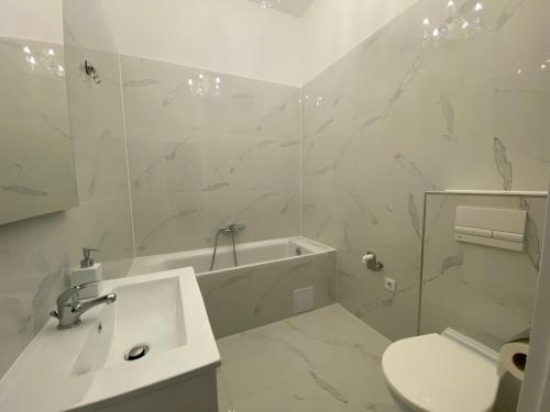 a white bathroom with a sink and a toilet at Vienna Luxury Dream Home in Vienna
