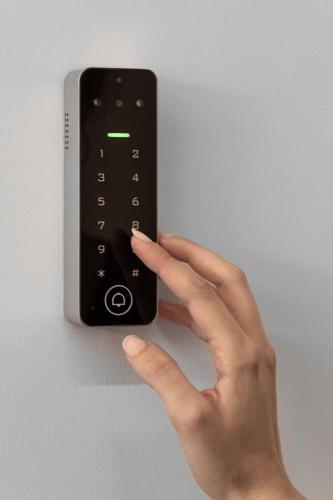 a person holding a remote control on a wall at Fits Living in Athens