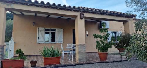 a patio of a house with plants in pots at Spacious Villa with Pool in Pruna, 140 m² in Pruna