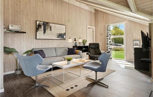a living room with a couch and chairs and a table at Three-Bedroom Holiday Home In Sydals in Skovbyballe