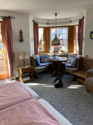 a bedroom with a bed and a dog laying on the floor at Alpenrose komfortable Ferienresidenz in Oberstdorf