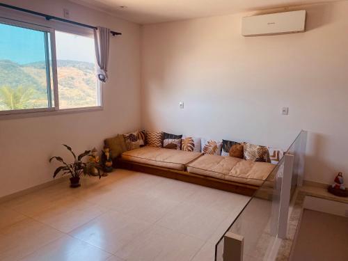 a living room with a couch and a window at Villa A with Sea View in Garopaba