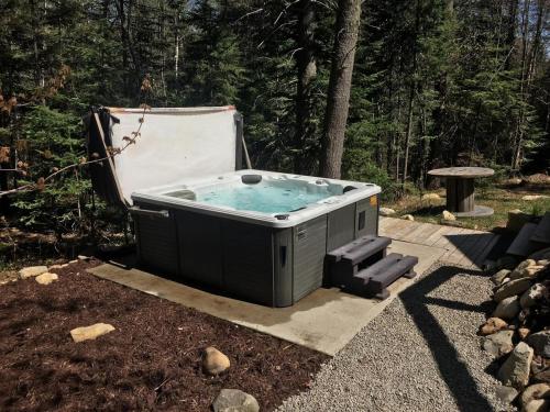 a hot tub sitting in the middle of a yard at Zazz - For precious moments with family or friends in Chertsey