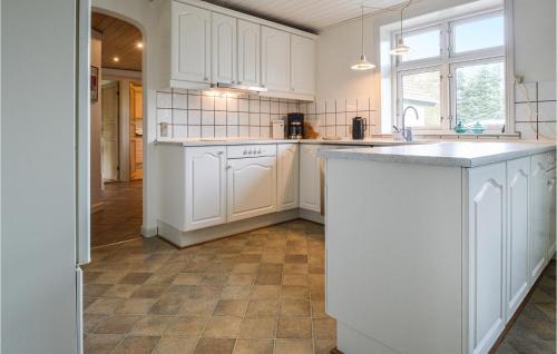 a kitchen with white cabinets and a tile floor at Gorgeous Home In Grindsted With Wifi in Grindsted