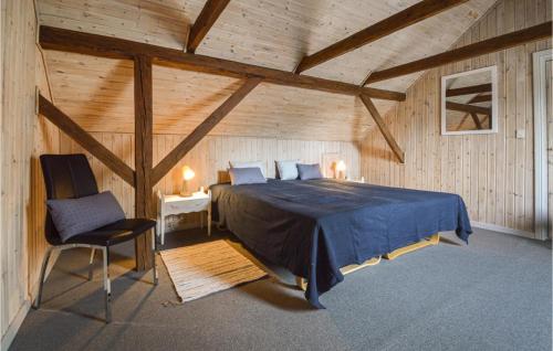 a bedroom with a bed and a chair in a attic at Gorgeous Home In Grindsted With Wifi in Grindsted