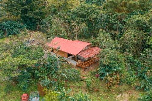 an overhead view of a house with a red roof at La Tigra Rainforest Lodge in Fortuna