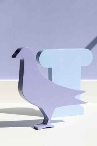 a white bird is sitting on the ground at Fits Living in Athens