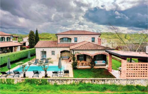 a large house with a swimming pool in front of it at Villa Montona in Višnjan