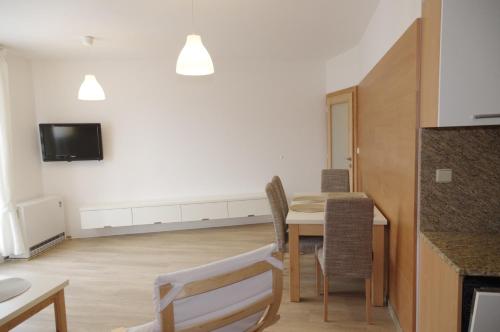 a kitchen and dining room with a table and chairs at Apartmá 11 Deštné v Orlických horách in Deštné v Orlických horách