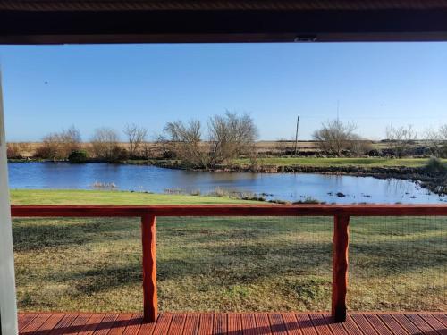a bench sitting in front of a view of a pond at Wildflower Eco Lodges in Fraserburgh