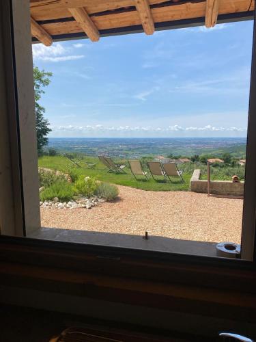 a window looking out at a view of a field at Agriturismo La Perlara - Adults Only in Verona