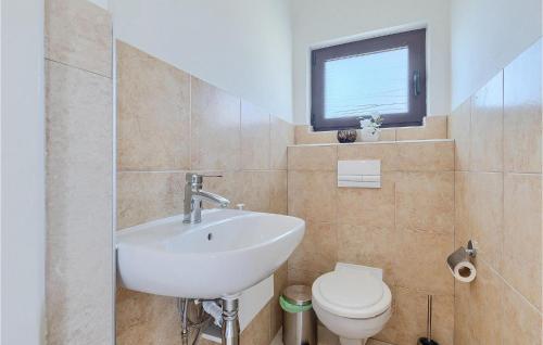 a bathroom with a sink and a toilet at Villa Mendula in Potpićan