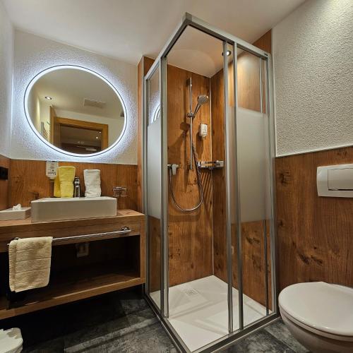 a bathroom with a shower and a sink at Appartements Kardona in Ischgl