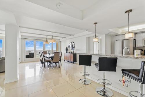 a kitchen and dining room with a table and chairs at Bahia Mar-Solare Tower, Beachfront Resort with Two Pools in South Padre Island