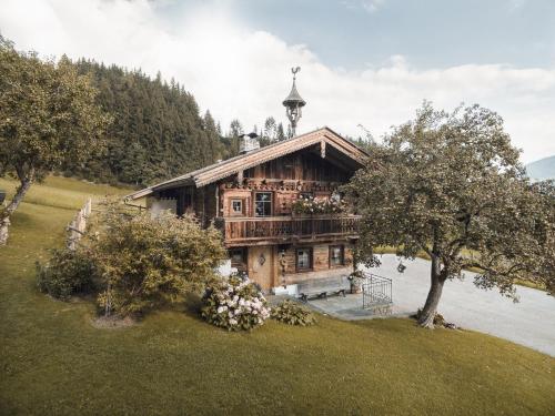 a wooden house with a tower on top of it at Alpen-Chalet-Pankraz in Fügenberg