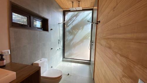 ein Badezimmer mit Dusche und Toilette und einem Fenster in der Unterkunft Casa Morro Punta de Lobos in Pichilemu