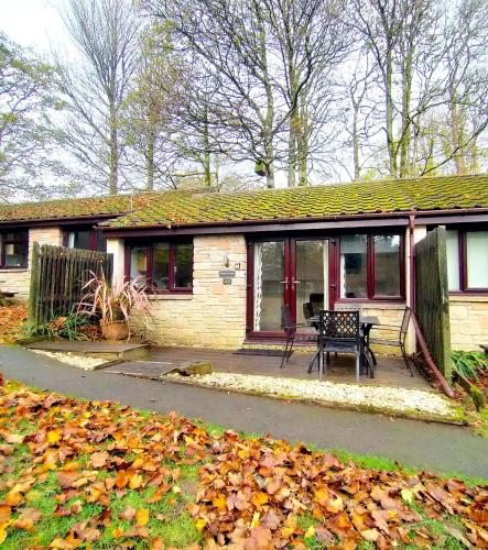 a house with a porch with a bench on it at Woodland View - Families & Pets in Uny Lelant