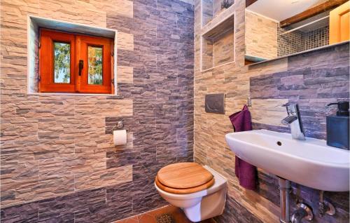 a bathroom with a wooden toilet and a sink at Holiday Home Gradec in Brežane Lekeničke
