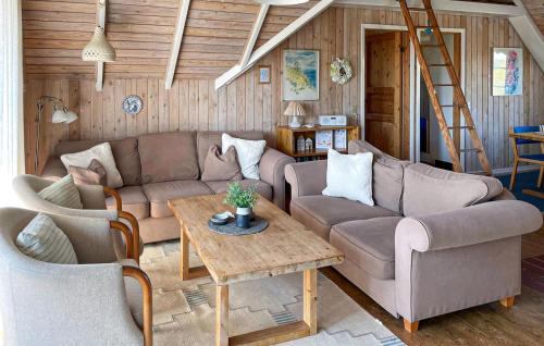 a living room with a couch and a table at Holiday Home Fanø 24 in Fanø