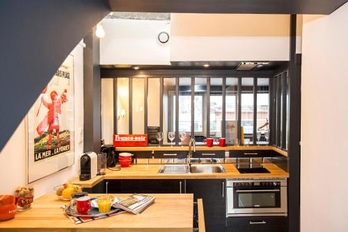 une cuisine avec un évier et un plan de travail dans l'établissement Little Suite - Romain, à Lille