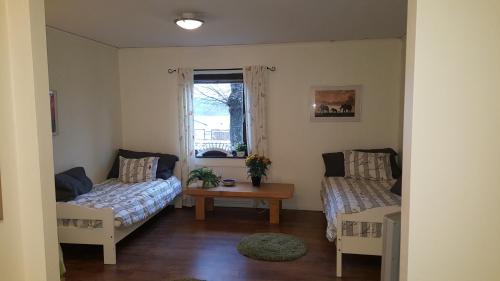 a living room with a couch and a table at Ekhult Apartments - Ground Floor - Garden and Lake View in Ulricehamn