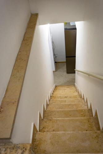 a stairway leading up to a room with white walls at Rosa azzurra in Casamassima
