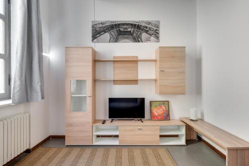 a living room with a built in entertainment center with a tv at Bigattera Apartments in Varese
